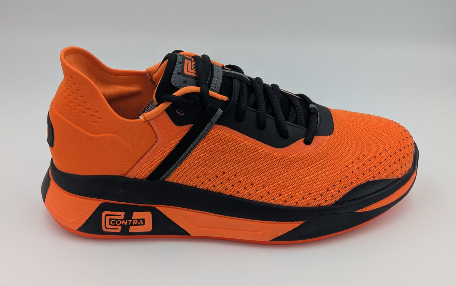 Orange and black sneaker on a light gray background