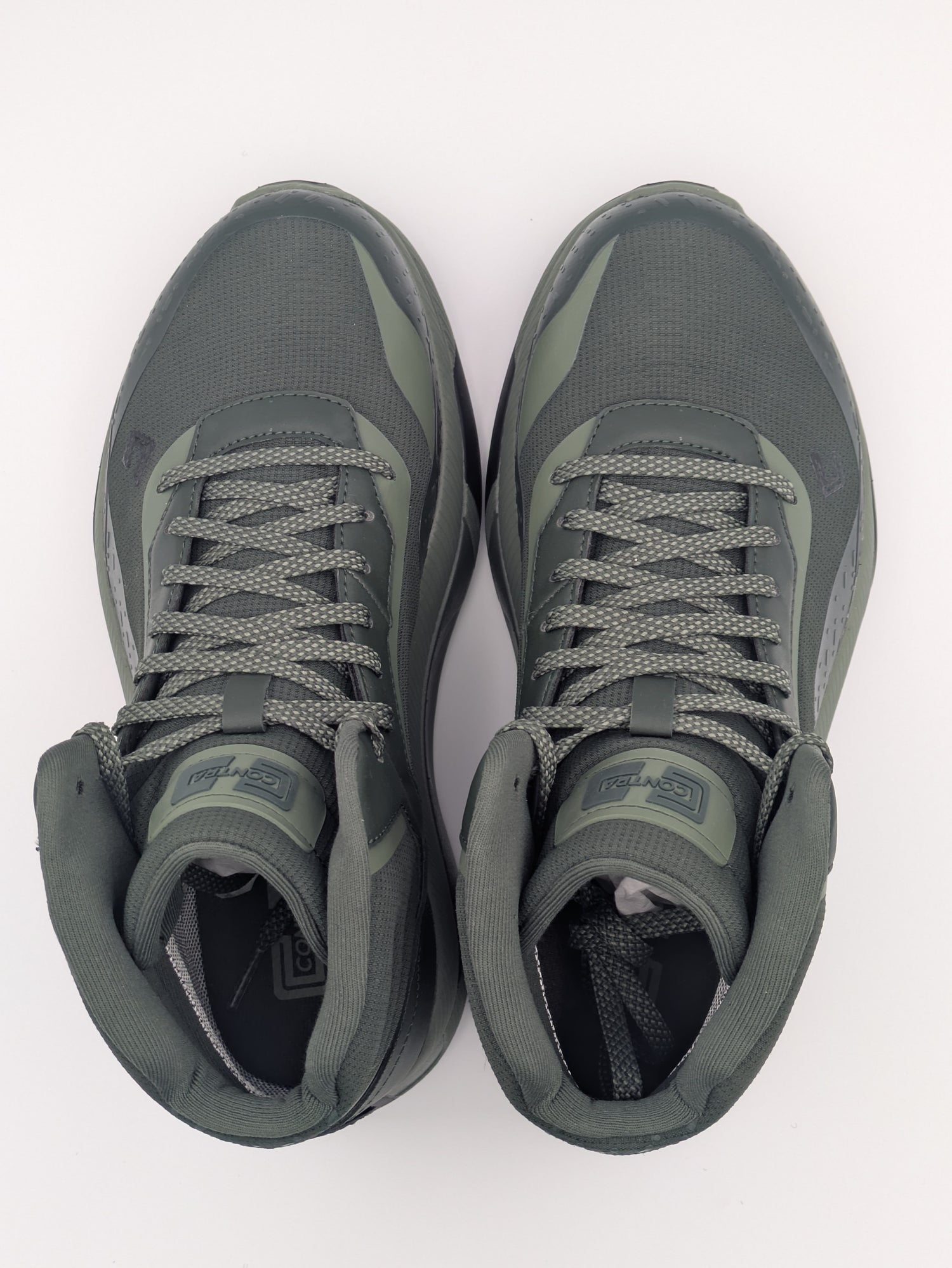 Pair of sage green sneakers on a white background