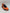 Orange and black sneaker on a light gray background